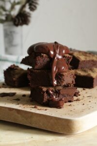 close up photo of stacked brownies on chopping board