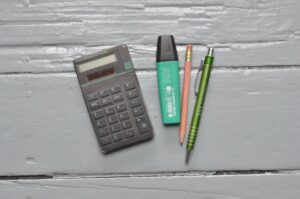 calculator near stationery on white table